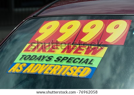 windshield price sticker on a used car lot for sale