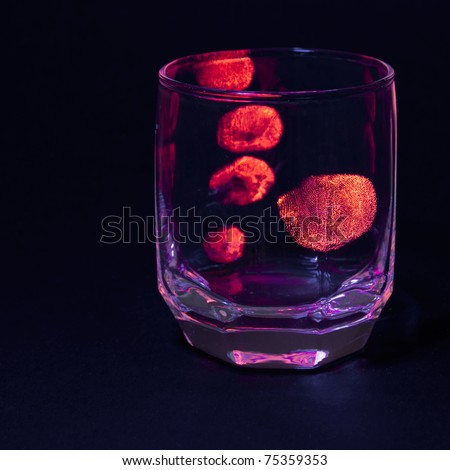 Finger prints on glass revealed under UV light.