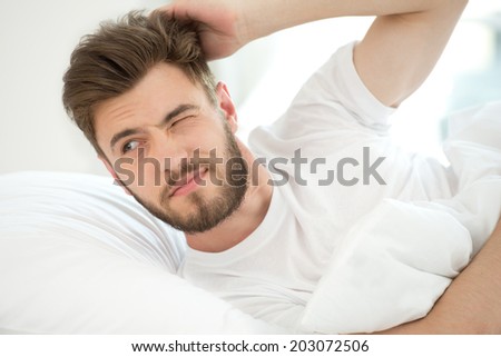 Young man trying to wake up
