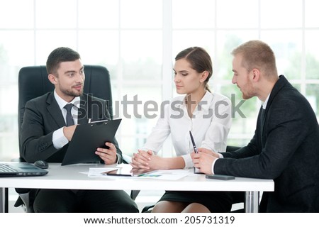 Business man with folder explaining things to his team