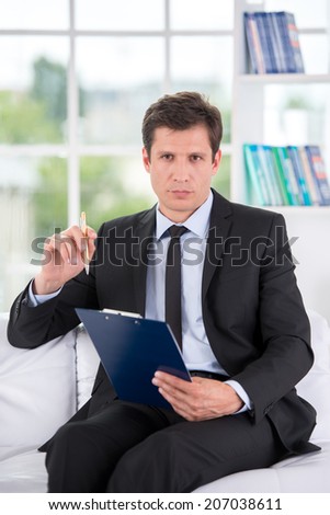 Portrait of male psychologist in his office