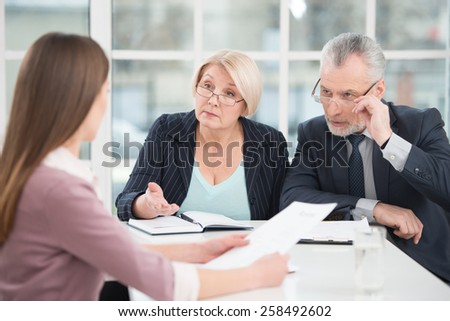 Young woman having an interview or business meeting with employers. Office interior with big window