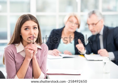 Young woman having an interview or business meeting with employers. Woman really wanting to get the job. Office interior with big window