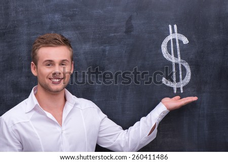 Smiling man in white shirt standing in front of blackboard background