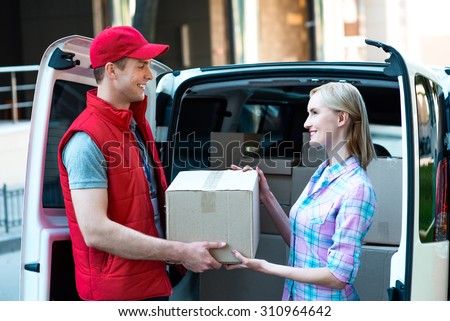 First class delivery service. Courier Delivering Package By Van.