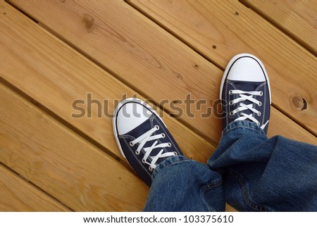 Canvas basket ball shoes on clean wood deck