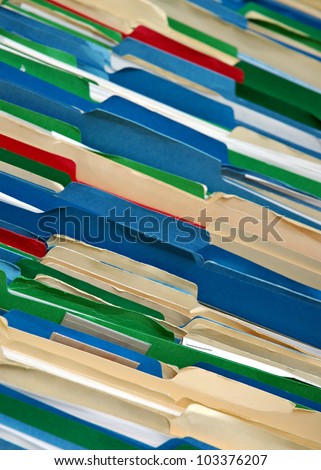 Messy filing cabinet with multi-colored file folders