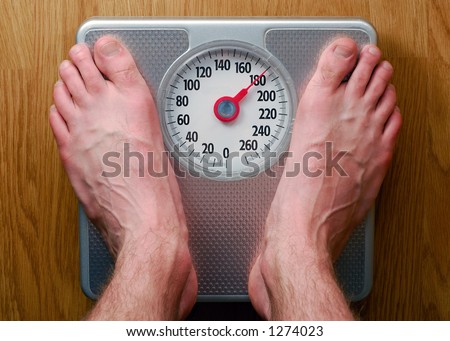 Man's Feet Standing on Bathroom Scale Man's Feet Standing on Bathroom Scale