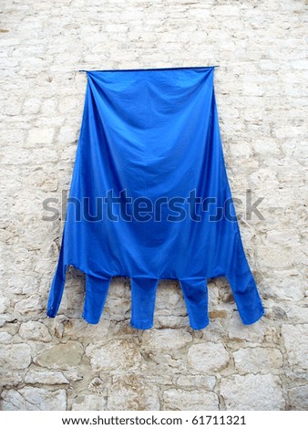 blank blue flag on castle wall