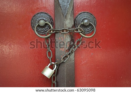 ancient Chinese red door with chain and key locked