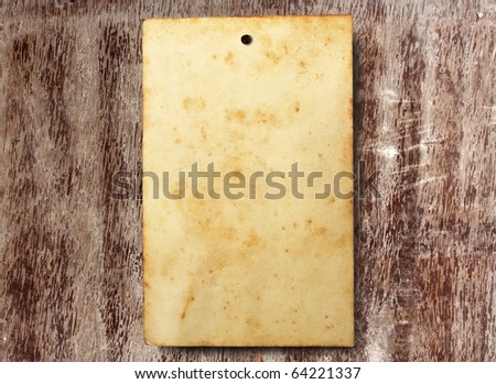 old paper attached on grunge teak wood background by a rusty nail