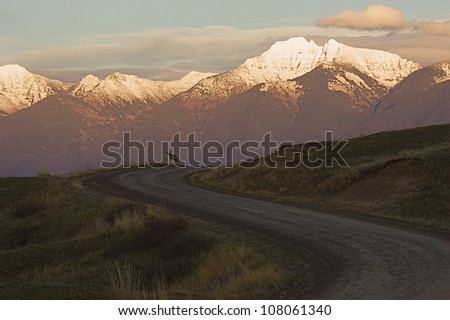 Gravel Road in the National Bison Range, Montana, featuring a Buck Deer, and the Mission Mountains