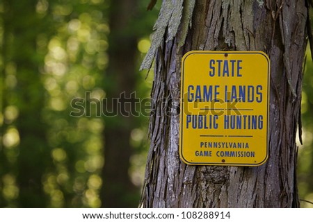 Pennsylvania Game Commission sign, STATE GAME LANDS - PUBLIC HUNTING, on a Shagbark Hickory tree