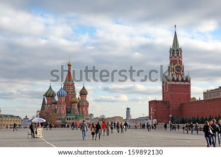 MOSCOW - OCT 22: People at Red Square with Saint Basil Cathedral and Spasskaya Tower in Moscow on October 22, 2013. Red Square is central place and popular site in Moscow