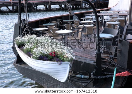 The Empty street cafe on boat and little boat with flower