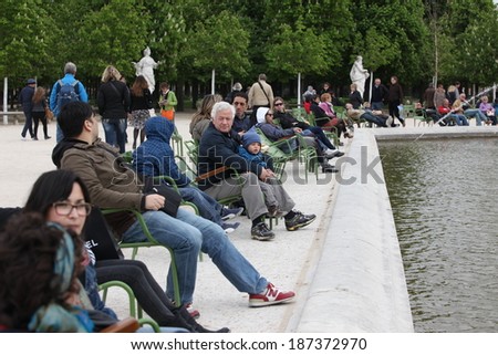 PARIS - APRIL 24, 2012: People in the famous Tuileries garden in Paris. Tuileries Garden is a public garden located between the Louvre Museum and the Place de la Concorde and very popular sitte