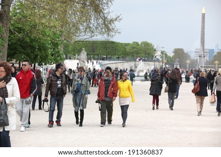PARIS - APRIL 24 2013:People in the famous Tuileries garden in Paris. Tuileries Garden is a public garden located between the Louvre Museum and the Place de la Concorde and very popular sitte