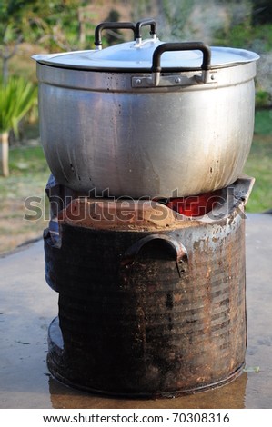 Rice Cooking with pot on charcoal brazier