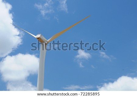 wind turbine propeller blades against sky