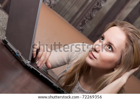 Attractive blonde girl working on a computer