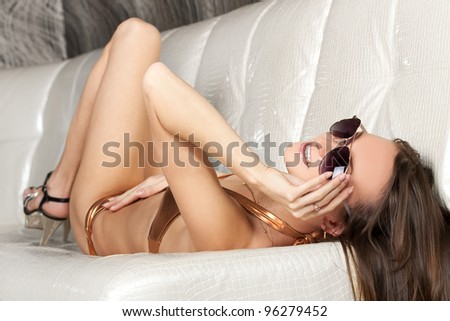 Seductive fashion model in seductive golden bikini