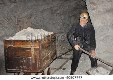 Puppet of miner placed in working scene inside mine