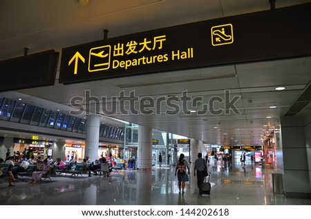 GUANGZHOU, CHINA-JUNE 22: Departure hall sign board in Guangzhou Baiyun International Airport on June 22, 2013. Guangzhou is the third largest city in China.