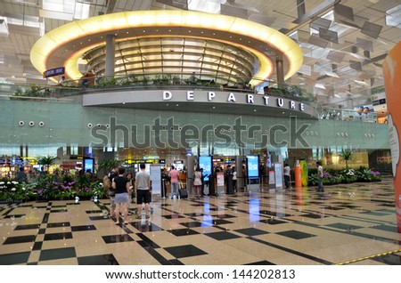 SINGAPORE-JUNE 14: Passengers leave via departure hall in Terminal 3 in Changi Airport, Singapore on June 14, 2013. Singapore airport is the main aviation hub in South East Asia.