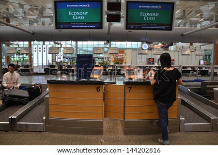 SINGAPORE-JUNE 14: Passenger is check in at the Singapore airline counter in Changi Airport, Singapore on June 14, 2013. Singapore airport is the main aviation hub in South East Asia.