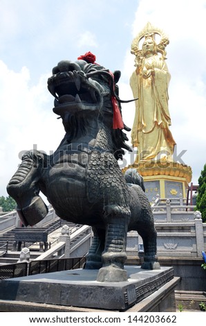 GUANGZHOU, CHINA-JUNE 18: Chinese lion guards the buddha on top of Lian Hua Mountain on June 18, 2013. The park is one of the eight most famous tourist attractions in Guangzhou.