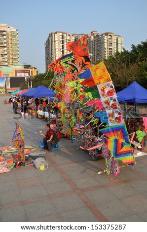 GUILIN, CHINA - MARCH 24: Peaple sells kites on the open space near the park on March 24, 2012 in Guilin, China. In China, flying a kite is a very popular leisure activity for children and teenagers
