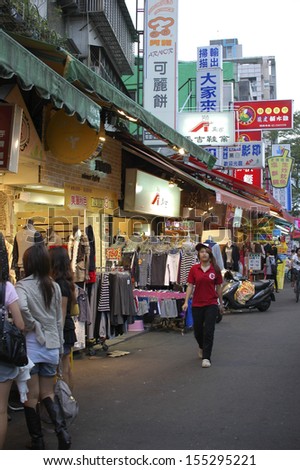 TAIPEI, TAIWAN-JUNE 14: Pedestrians enjoys shopping a night market on June 14, 2013 in Taipei, Taiwan. There are over 100 night markets scattered throughout the city.