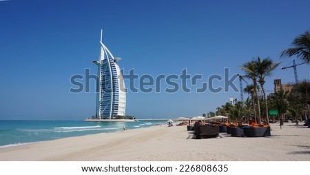DUBAI, UNITED ARAB EMIRATES -OCTOBER 18, 2014: View of Burj Al Arab hotel from the Jumeirah beach. Burj Al Arab is one of the Dubai landmark, and one of the world\'s most luxurious hotels with 7 stars.
