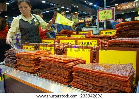 MACAU, CHINA - NOV 19: Shop-keeper sells assortment of Chinese preserved meat in Macau on November 19, 2014. Chinese preserved meat usually is made with beef, pork, or mutton.