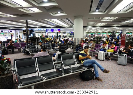HONG KONG-NOV 19: Passengers wait for the transit flight the airport lobby of Hong Kong airport on November 19, 2014 in Hong Kong. Hong Kong airport handles more than 55 million passengers per year.