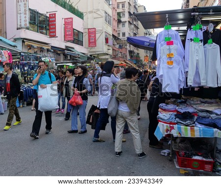 HONG KONG - NOVEMBER 22 :Tourist shops for bargain priced fashion and casual wear in Mong Kong market on 22 November 2014. The market is famous with many booths selling local products.