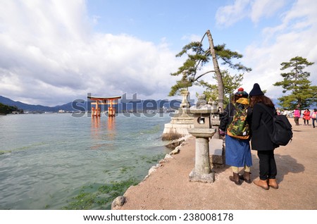MIYAJIMA, JAPAN - DEC 10: Tourists visit Itsukushima shrine in Miyajima, Japan on December 10, 2014. Itsukushima Shrine is a shrine on the island of Miyajima, best known for its \