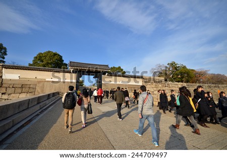 OSAKA, JAPAN - DECEMBER 04 2014: Tourists visit Osaka Castle in Japan on December 04, 2014. Osaka Castle was first built in 1583 on the former site of the Ishiyama Honganji Temple.