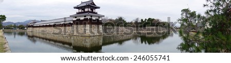HIROSHIMA, JAPAN - DECEMBER 12: Entrance at Hiroshima castle with wall and water pond to protect from the enemy. Hiroshima, Japan on December 12, 2014.