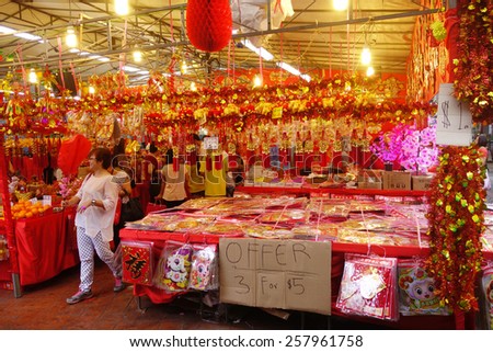 SINGAPORE - FEB 15: Customers shop for Chinese New Year ornaments displayed in a Singapore local market on 15 February, 2015. Chinese New Year is an important festival in Singapore.