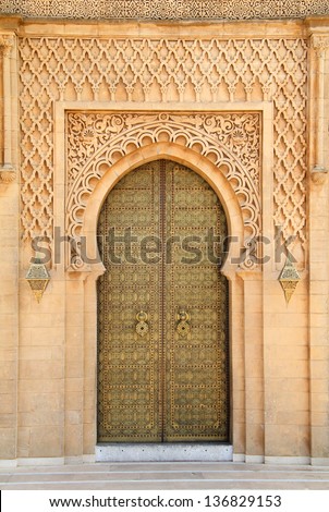 Morocco, Rabat, typical old arabesque intricate engraved brass door and surround in sandstone  sculpted in detailed Islamic design