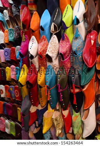 Morocco, Marrakesh, Typical colorful \'babuchas\' - hand crafted leather slippers on display in the Medina souk. UNESCO World Heritage site.