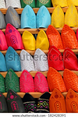 Morocco, Marrakesh, Typical colourful \'babuchas\' - hand crafted leather slippers on display in the Medina souk. UNESCO World Heritage site.