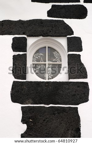 Portugal Azores Islands Sao Miguel typical round window built into black volcanic rock
