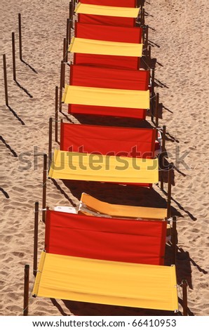 Portugal Algarve orange and yellow sun shades on a golden sandy beach