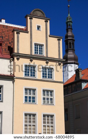 Estonia Tallinn historical center simple art nouveau or German jungendstil building facade with copper clad church spire in background