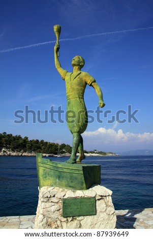 Greece Greek Isles Paxos Statue of a young at the old harbor entrance - Paxos landmark