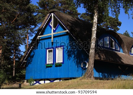 Lithuania Klaipeda typical colorful wooden home with thatched roof