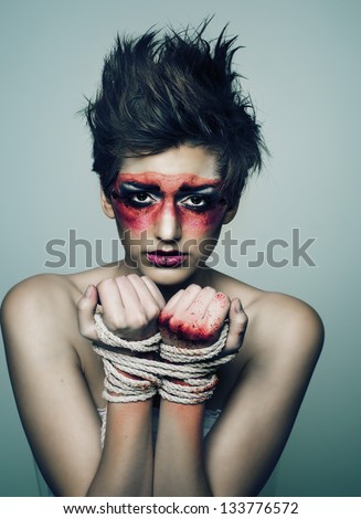 Concept image of wounded woman constrained, tied up.