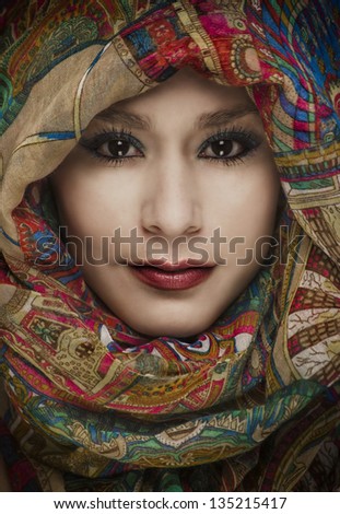 Beautiful woman wearing colorful head scarf